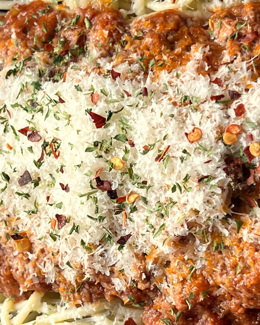 Our spaghetti bolognese, close up: parmesan, chilli flakes and herbs